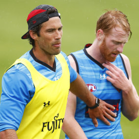 New Essendon development coach Alex Rance encourages Bombers utility Aaron Francis.