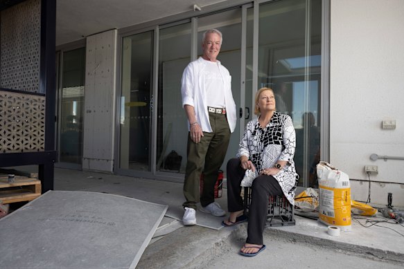 Andrew and Lisa Cook on their balcony, which is still being repaired.