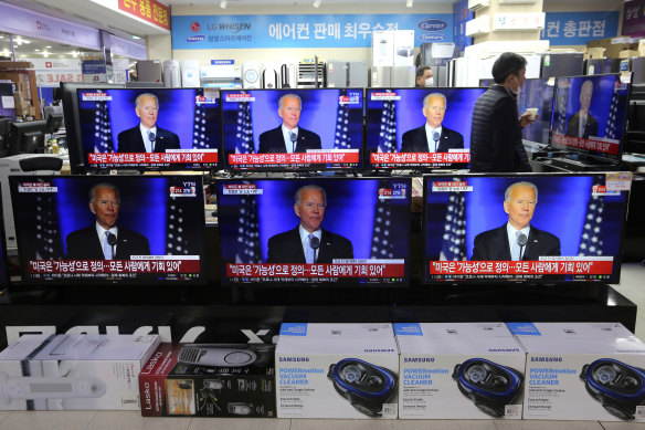 Screens in an electronics store in Seoul, South Korea show US President-elect Joe Biden speaking.