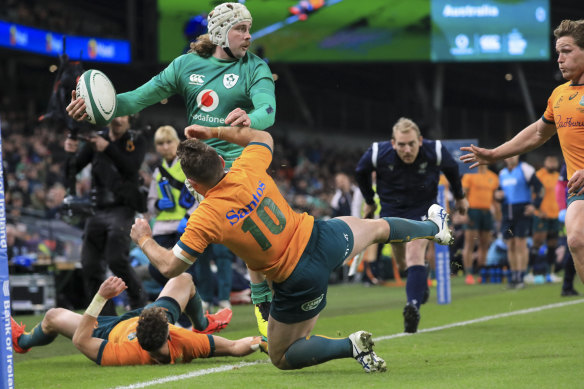 Bernard Foley makes a try-saving tackle on Mack Hansen.