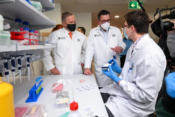 Anthony Albanese and Daniel Andrews in a laboratory at Mo<em></em>nash University on Monday.