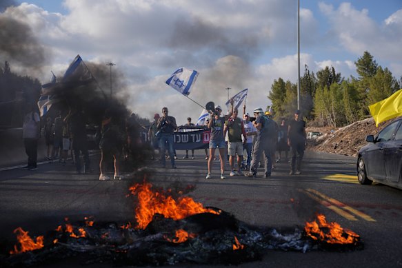 Demonstrators block a road during a protest demanding the immediate release of hostages.
