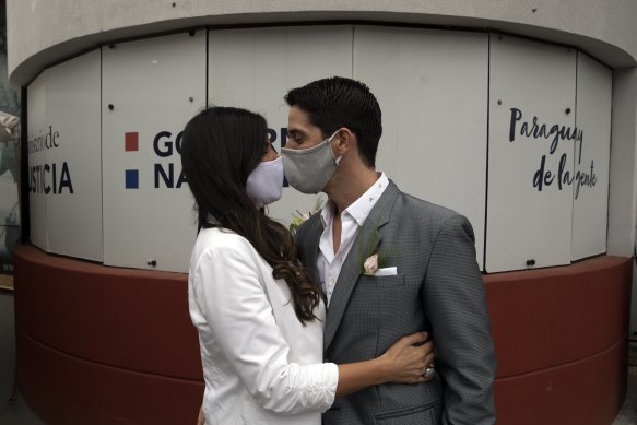 Bride Loris Sanchez and groom Manuel Soria share a kiss before their wedding ceremony at the Civil Registry office, in Asuncion, Paraguay on Saturday, June 13. 