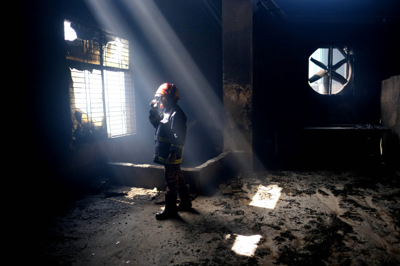 A firefighter inside the burnt food and beverage factory.