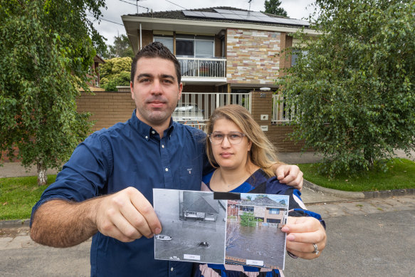 Lee and Selin Lanzafame in January holding up two images of their flooded home, taken 48 years apart.