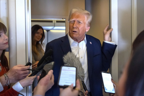 President Donald Trump speaks to reporters aboard Air Force One as he travelled from Las Vegas to Miami.