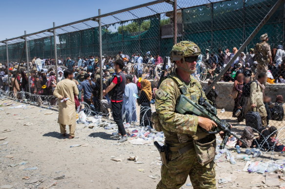 Australian soliders locating Afghan Australian visa holders attempting to enter the congested Abbey Gate at Hamid Karzai International Airport before the withdrawal.