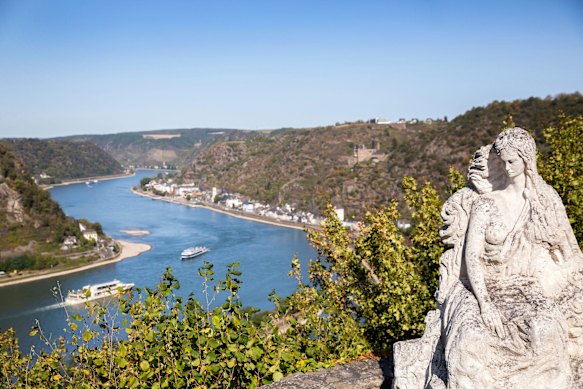 A statue of the  mythical Lorelei atop the eponymous rock formation along the Rhine Gorge. 