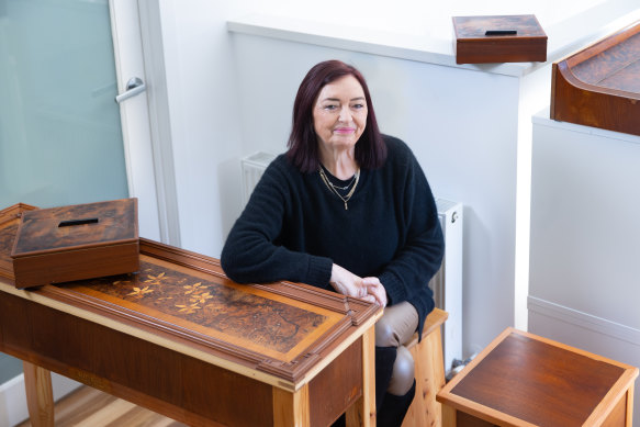 Helenmary Burnside with some of the furniture made from her piano.