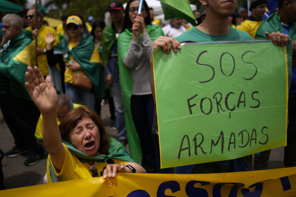 A supporter of outgoing President Jair Bolsonaro prays during a protest against his defeat in the country’s presidential runoff, outside a military base in Sao Paulo, Brazil, on Saturday.