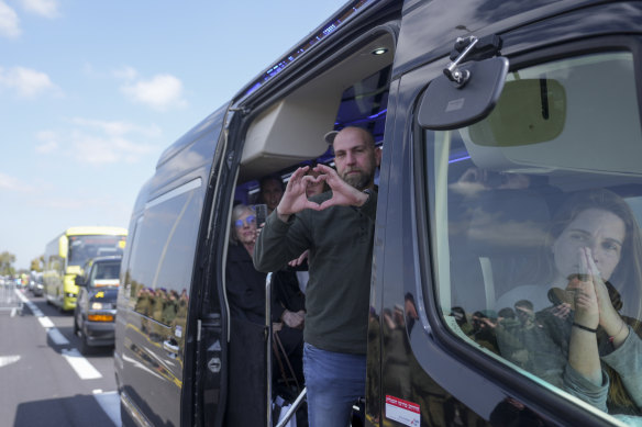 Relatives of the Bibas family show their appreciation to crowds along the road leading to the funeral.