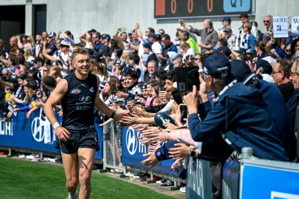 Carlton captain Patrick Cripps greets fans at training this week in Melbourne. The Blues are expected to arrive in Brisbane on Friday. 