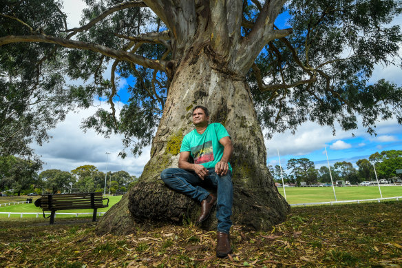 Nicky Winmar next to a eucalypt at Ivanhoe Park football oval where Sir Doug Nicholls used to watch games.