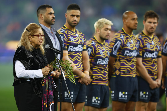 Aunty Joy Murphy performs a Welcome to Country before the round 12 game in 2022 as Storm players line up in their Indigenous jumpers.