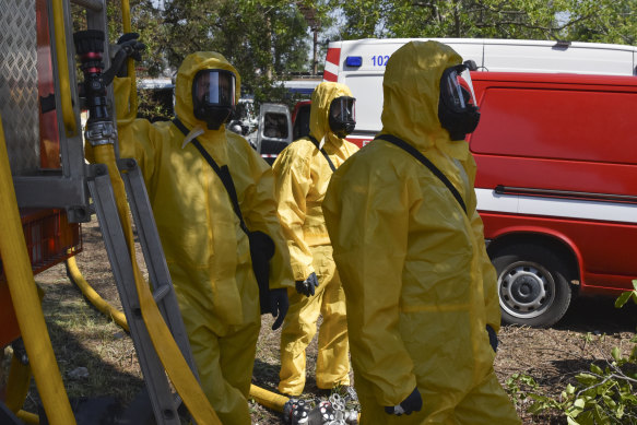 Ukrainian emergency workers wearing radiation protection suits attend training in Zaporizhzhia, Ukraine, where Europe’s biggest nuclear plant relies in large part on water from the now-emptying reservoir at the Kakhovka dam. 