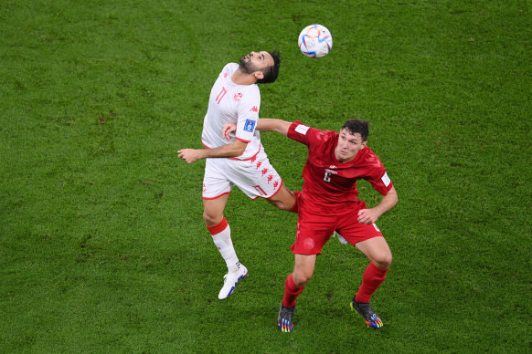 Tunisia’s Taha Yassine Khenissi and Dane Andreas Christensen challenge for the ball.