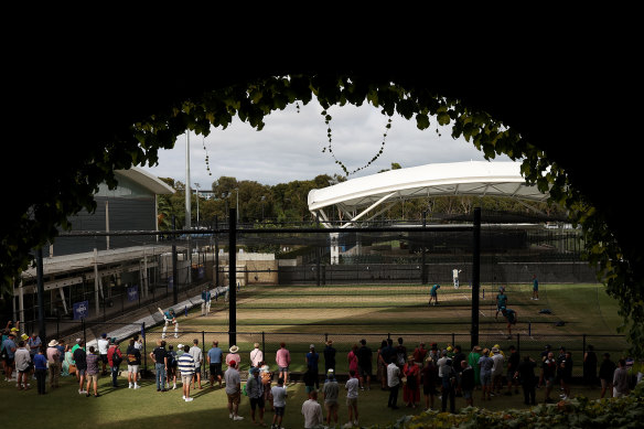 Spectators watch Australian players warming up in the nets in Adelaide.