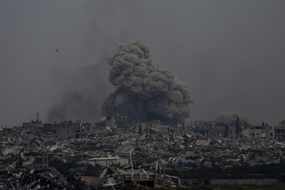 Smoke and explosions rise inside the Gaza Strip, as seen from southern Israel on Sunday.