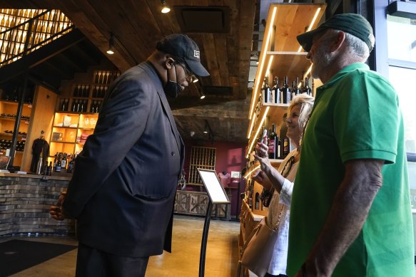 Security personnel ask customers for proof of vaccination as they enter City Winery in New York.