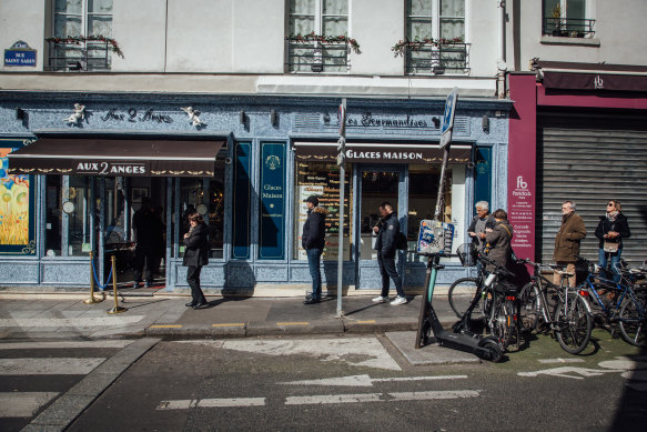 'Social distancing' outside a Paris bakery on Sunday. All shops, bars and restaurants  were closed. Only essential services, grocery stores and bakeries remained open for face-to-face customers. Fast-food outlets were closed, but were permitted to keep 'drive-thru' services open.