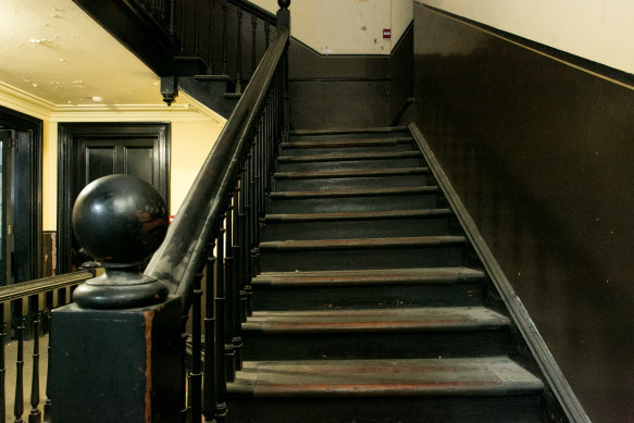 The original stairs remain copper-plated, worn and on a lean.