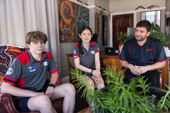 Barker College students Oliver Porter and Jiaqi Wan with robotics teacher Jeser Mross Becker safely back at the school.