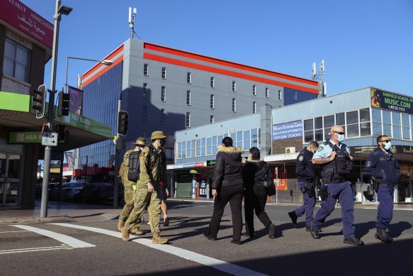 The ADF and NSW Police walking through Fairfield on Monday morning.