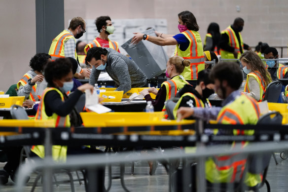 Philadelphia election workers process mail-in and absentee ballots for the general election, at the Pennsylvania Convention Center.