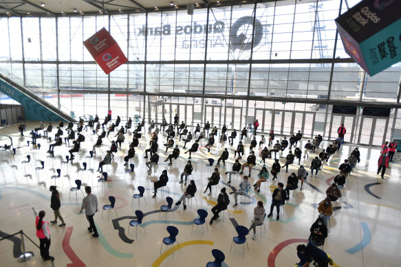 Year 12 students wait for the Pfizer vaccine at Sydney Olympic Park.