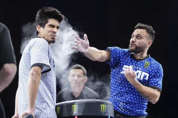 Azael Rodriguez slaps Jesus Gaspar at a Power Slap event in Rio De Janiero, Brazil. The competitors stand rigidly upright with their hands behind their backs, waiting to absorb a brutal slap to the face.