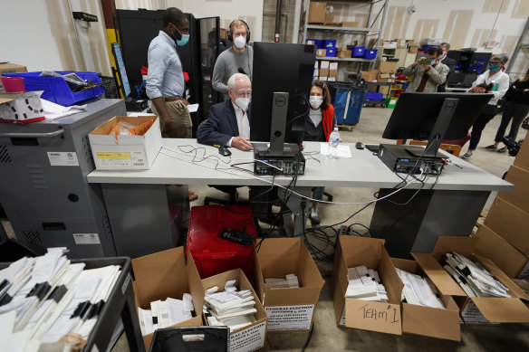 Democratic and Republican representatives review absentee ballots at the Fulton County election centre. 