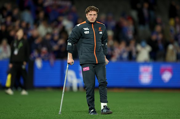 Toby McMullin of the Giants is seen on crutches post game.