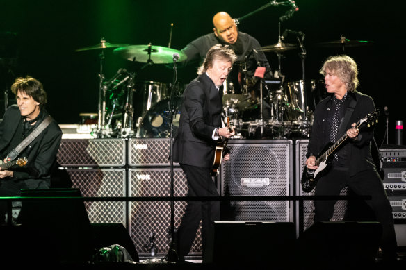 Paul McCartney rips it up on stage with the band at Allianz stadium. 