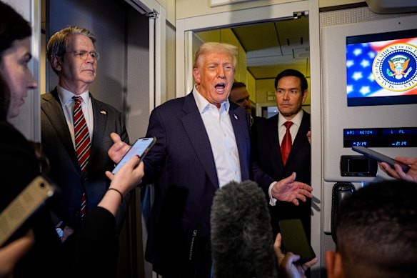 US President Donald Trump speaks to the media aboard Air Force One this week.