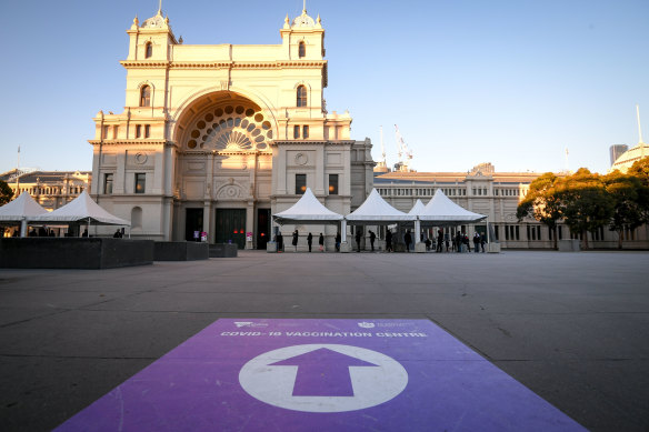 People queue to receive the COVID-19 vaccine at Melbourne’s Royal Exhibition Building. 