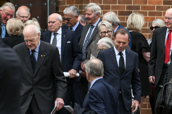 Former prime ministers John Howard and Tony Abbott with other mourners at Peter Reith’s memorial service on Thursday.