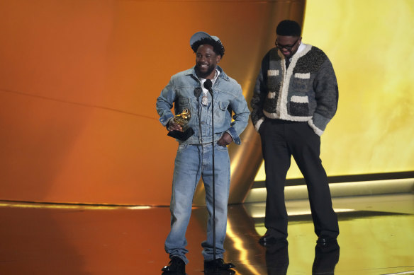 Kendrick Lamar (left) accepts the record of the year award for Not Like Us.