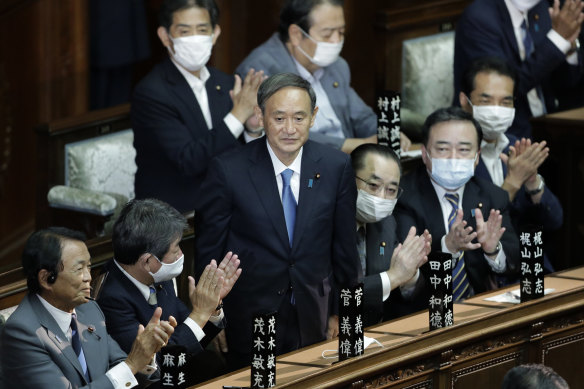Yoshihide Suga receives a round of applause after being elected PM during an extraordinary session at the lower house of parliament in Tokyo on Wednesday.