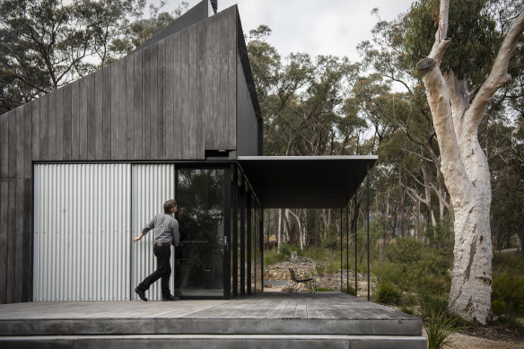 Simon Anderson closes up the house in four minutes, dropping the roof of the verandah and sliding across fire proof screens. 