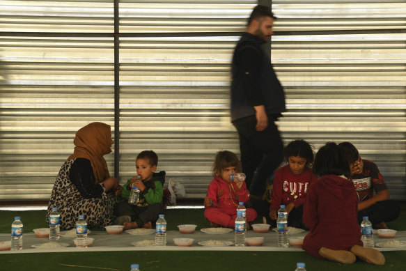 A Syrian family share a meal at the Bardarash Refugee Camp in Iraqi Kurdistan. 