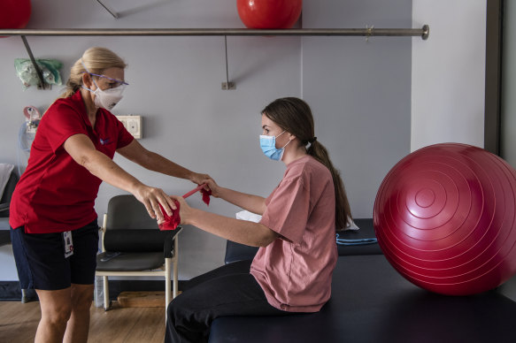 A patient works with a physiotherapist at NSW’s first long COVID clinic.