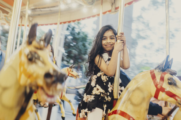 Seyara Algama, 6, on the Darling Harbour carousel on Friday. 