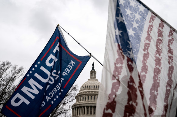 Supporters of President Donald Trump wave flags as they protest against the result of the presidential election in front of the Capitol in Washington on January 5.