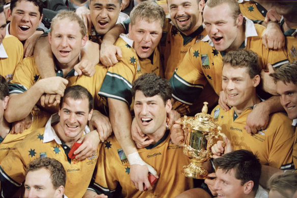 Australian captain John Eales (C) and his teammates celebrate after winning the 1999 Rugby Union World Cup final against France. 