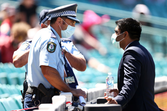 Police speak with a member of the Indian team staff on Sunday.