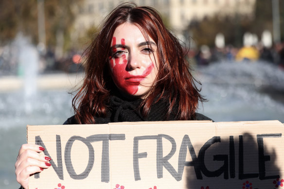 An activist holds a placard reading ‘Not Fragile’ as she takes part in the demonstration.