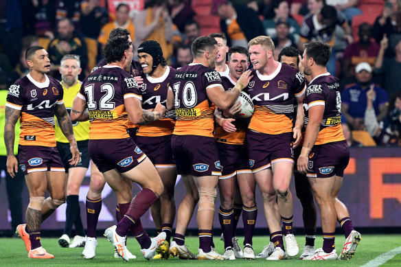 Brisbane players celebaret Tom Flegler’s try against Melbourne.