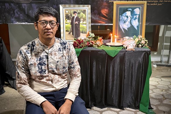 Mujib Munawan em frente a retratos do líder supremo do Irã assassinado no Centro Cultural Islâmico no sul de Jacarta. 