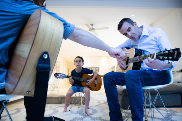 David Landau with his 7-year-old son, Ashton, took up guitar lessons during the COVID-19 pandemic.