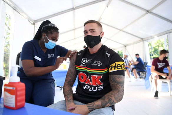 Penrith Panthers fan Shane Binns receives the COVID-19 vaccination at a pop-up clinic at Suncorp Stadium on Sunday.